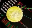 gold round coin on black surface