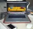 turned on MacBook Pro beside gray mug